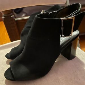 Black short black heels. Opened toed.